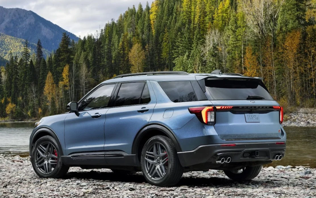 A 2025 Ford Explorer parked on the rocky shore of a river.